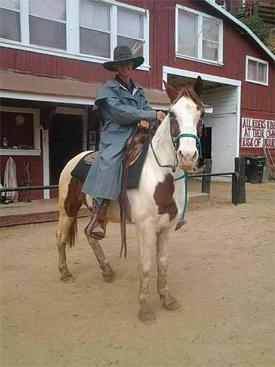 Hugh Englehart rides a mare named Elsa in front of the last hay barn in Los Angeles.