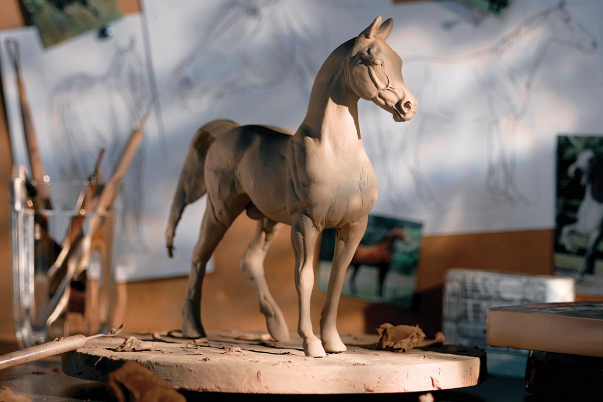 A clay sculpture of a horse during the process of creating a Breyer model.