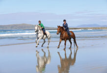 Horseback riding on a beach in Ireland on holiday.