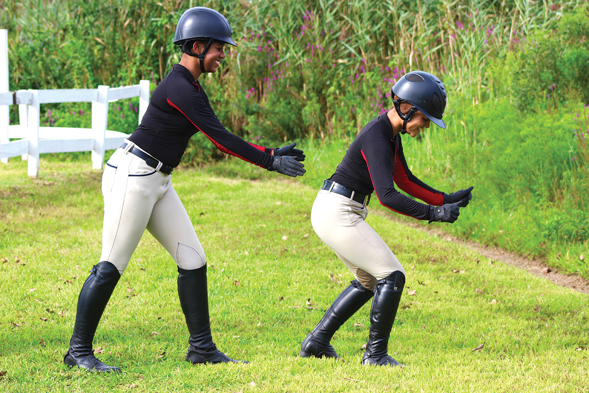 Equestrians practice a balancing exercise