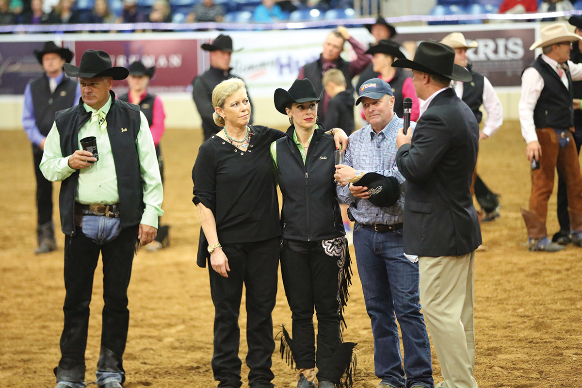 Horsemen and women gather in an arena