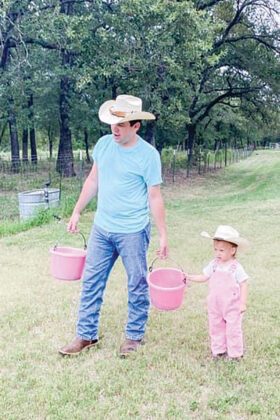 A young cowgirl with her cowboy dad