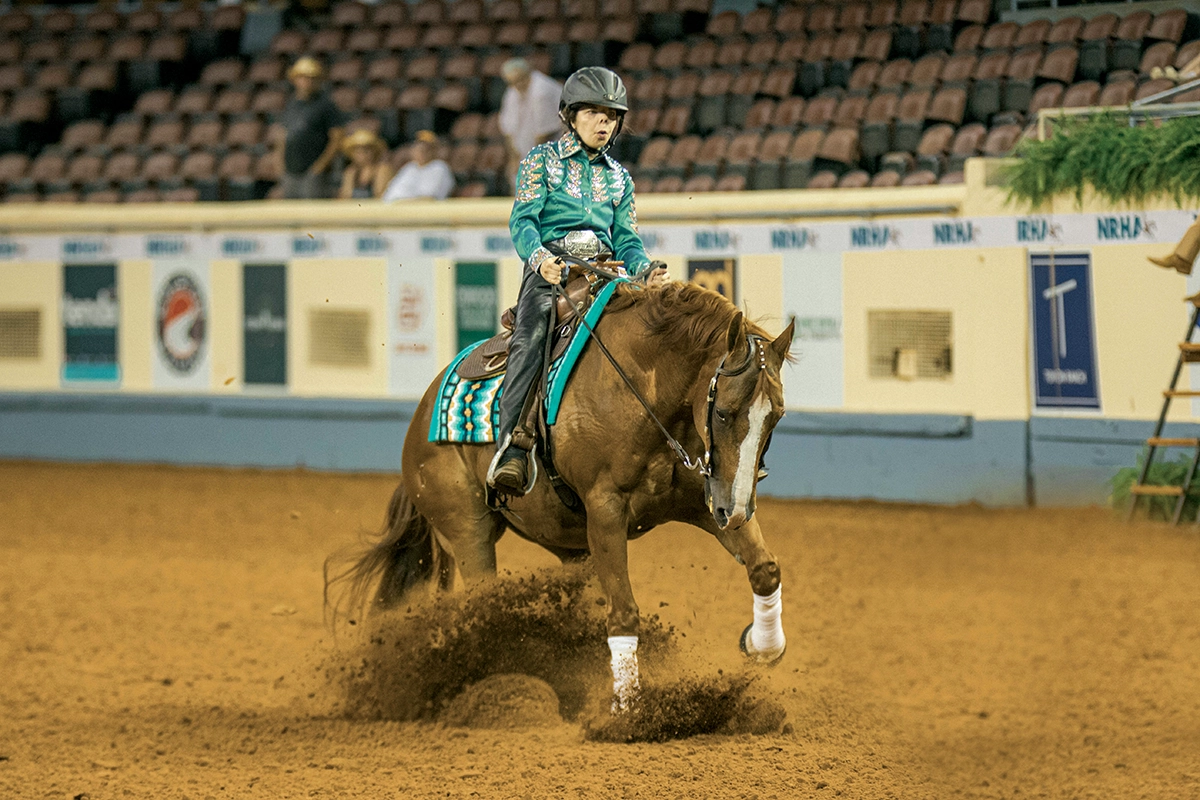 An equestrian with disabilities performs a sliding stop in Para-Reining.
