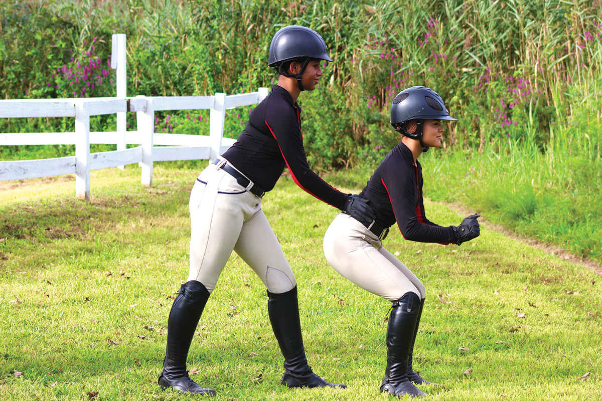 Equestrians practice a balancing exercise
