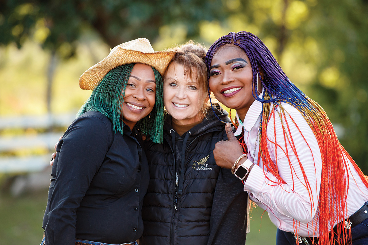 Kathy Zachmann (center) with two women from the Angel Reins Stable program.