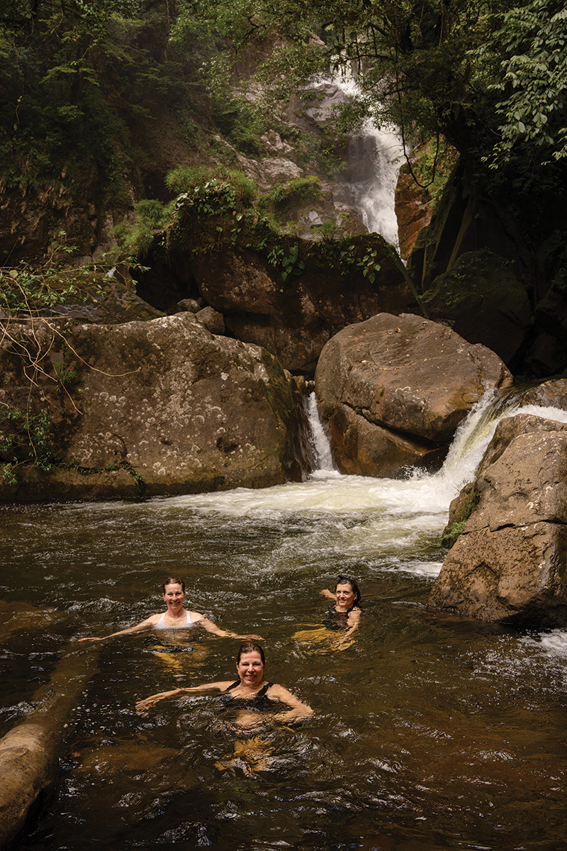 Going for a swim at the base of a waterfall.