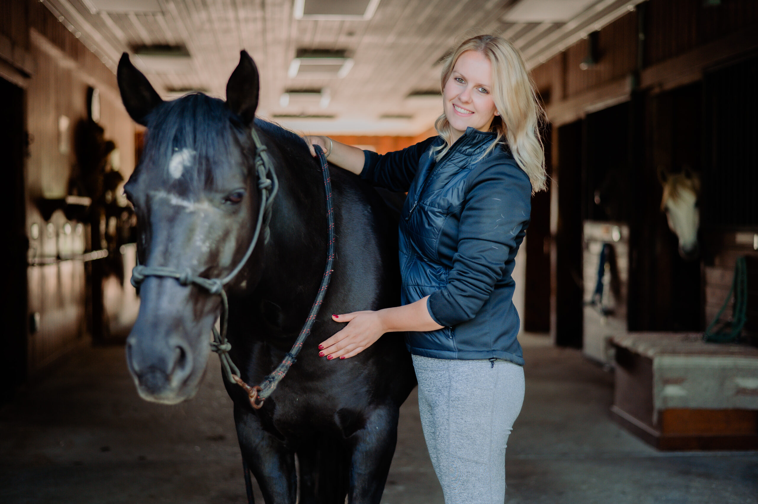 Jenny Zonghetti, an equine bodyworker based in Massachusetts, with a horse