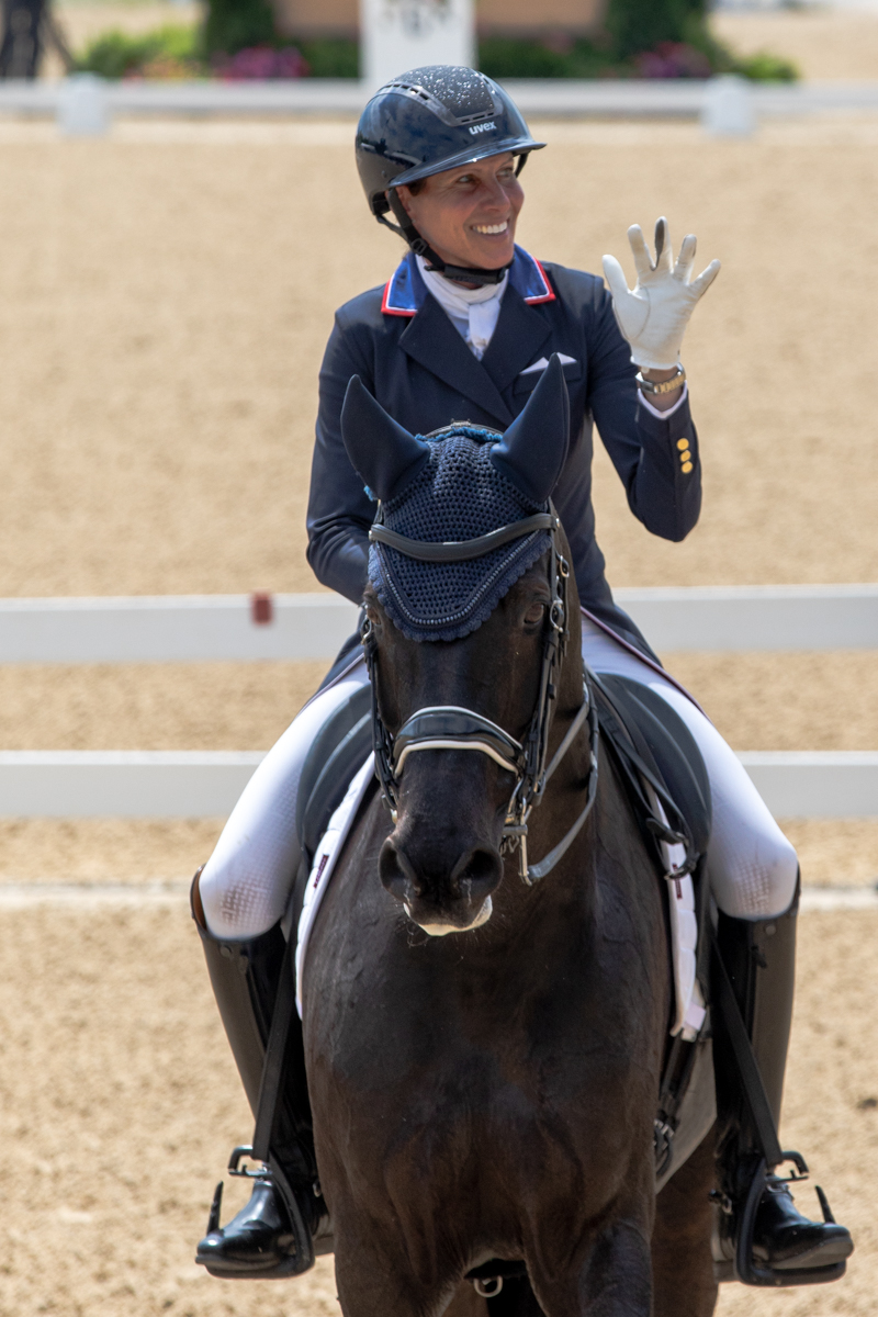 Liz Halliday-Sharp waves to the crowd as she exits the ring aboard Cooley Nutcracker