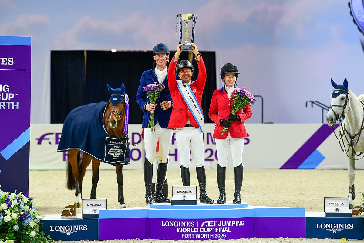 The USA's Kent Farrington hoists the Longines trophy on the FEI World Cup podium, alongside Germany's Daniel Deusser (second) and the USA’s Katie Dinan (third).