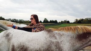 Woman petting horse.