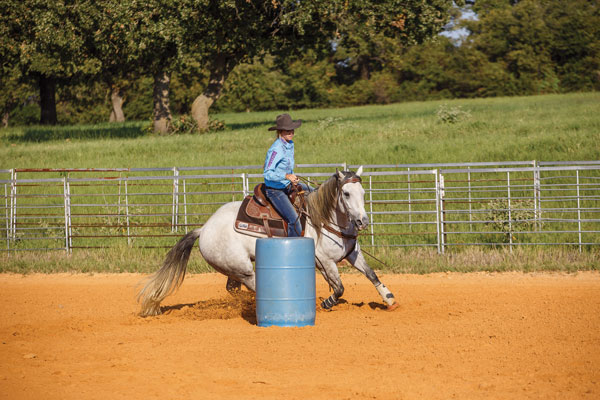 Horse barrel riding.