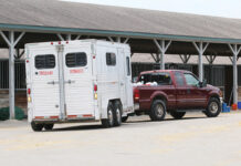 A truck backing a horse trailer, properly showing how to back a trailer
