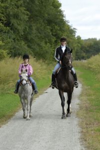 Mom and daughter riding horses.