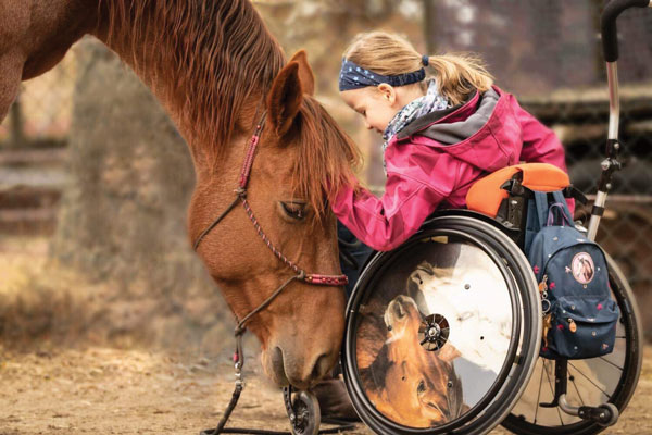 Mustang and little girl in wheelchair