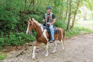 Horse rider with mounted orienteering gear.