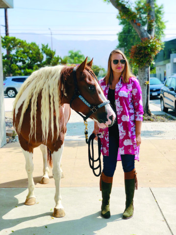 Raquel Lynn with her paint horse.