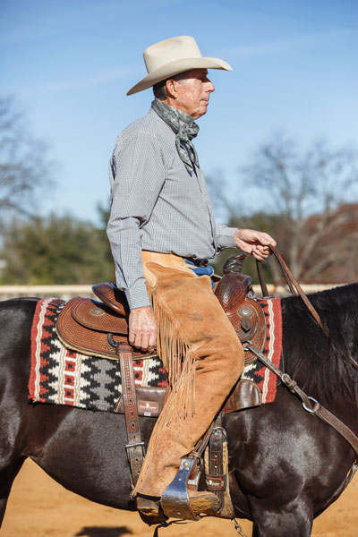Man in Too Small Western Saddle