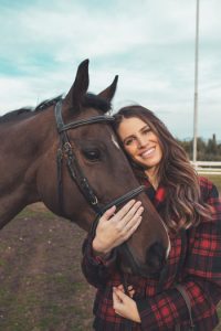 Woman hugging horse.